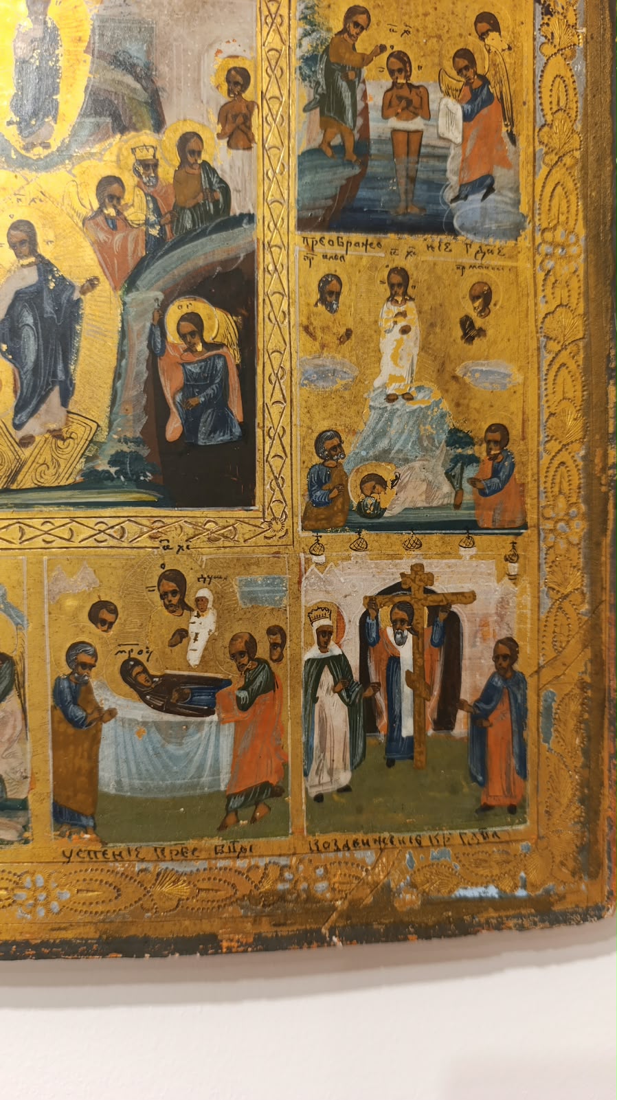 Close view of a narrative panel and saint